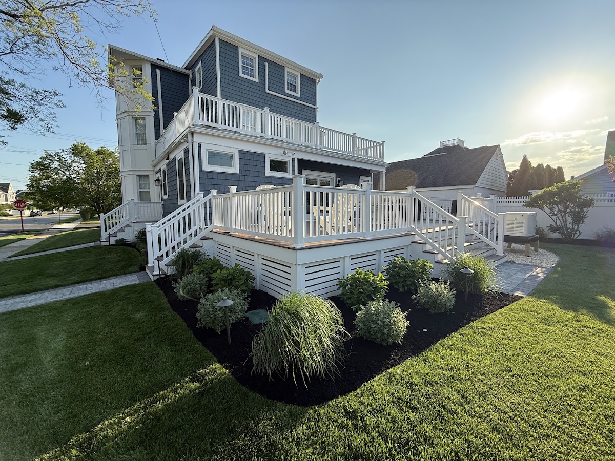 Backyard garden bed with ornamental grasses beside a coastal home